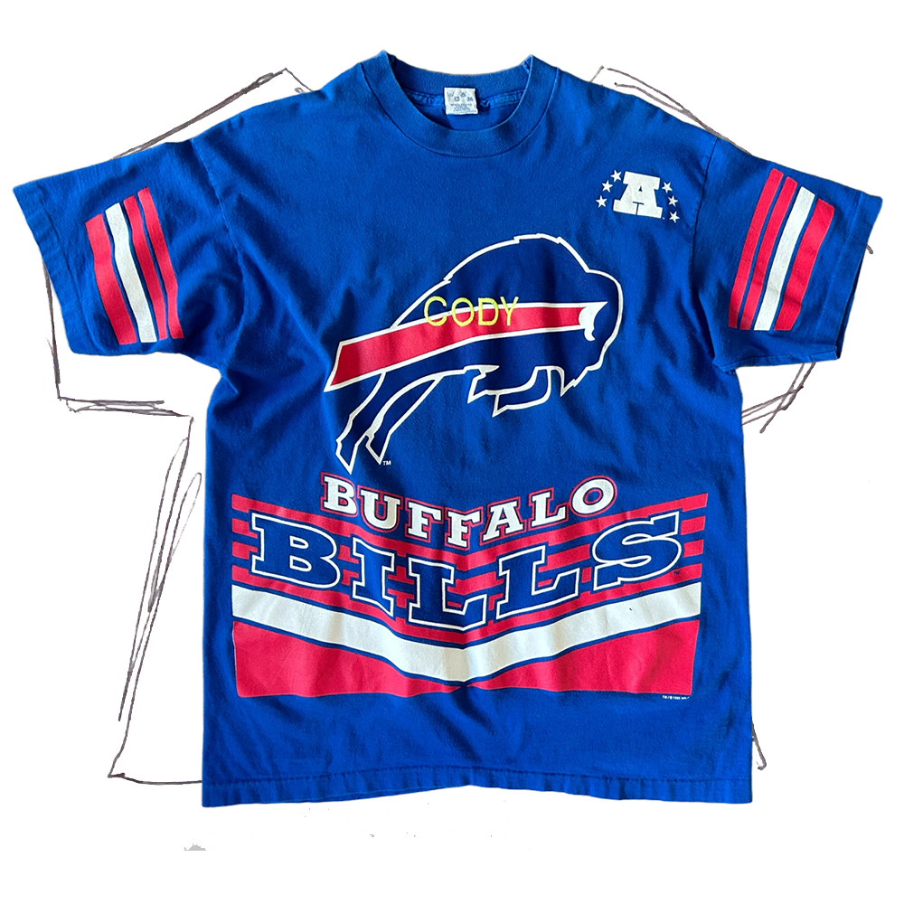 front of tshirt, royal blue buffalo bills logo center of shirt with pink/white stripes on sleeves, with neon yellow "cody" embroidered in center